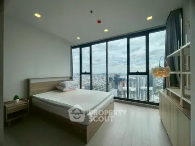 Modern bedroom with stunning city view and floor-to-ceiling windows