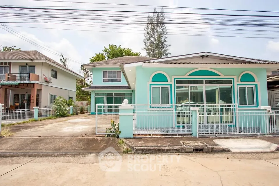 Charming two-story house with vibrant exterior and spacious driveway