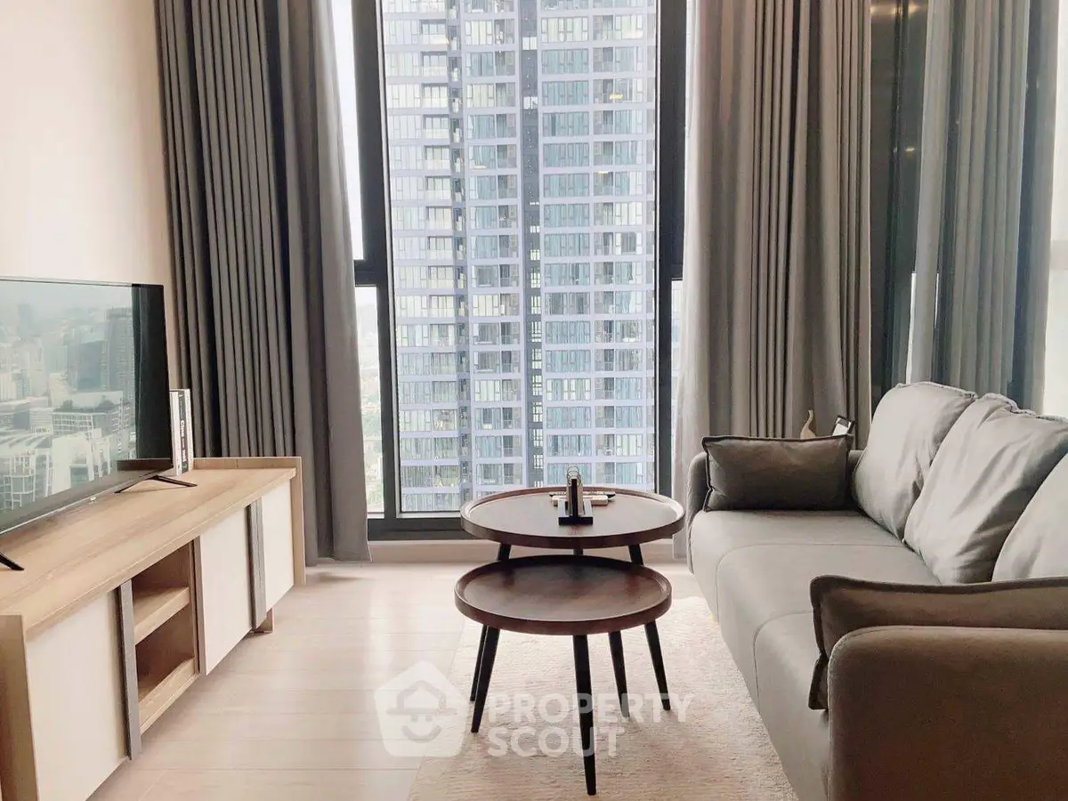 Modern living room with city view, stylish furniture, and large windows.