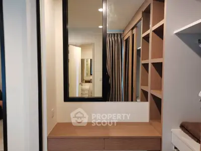 Modern bedroom with built-in wooden shelves and mirror, perfect for stylish storage solutions.