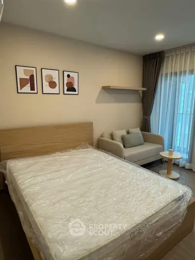 Modern bedroom with stylish decor and cozy seating area, perfect for relaxation.