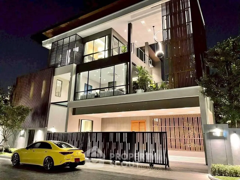 Stunning modern house exterior with sleek design and luxury car parked outside at night.