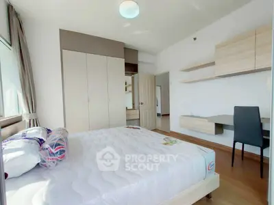 Bright and modern bedroom with built-in wardrobe and study desk, perfect for urban living.