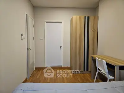 Cozy bedroom with wooden flooring, wardrobe, and study desk