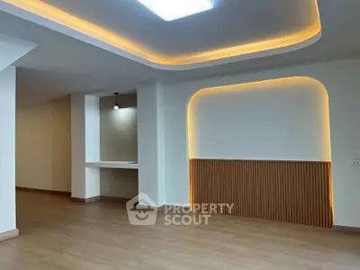 Modern living room with elegant ceiling lighting and wooden flooring