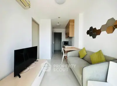 Modern living room with stylish decor and compact kitchen area