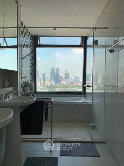 Modern bathroom with city view, glass shower, and elegant fixtures.
