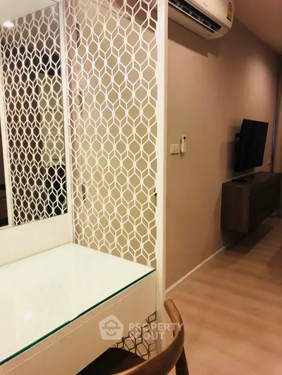 Modern interior with stylish partition and wall-mounted TV in a cozy living space.