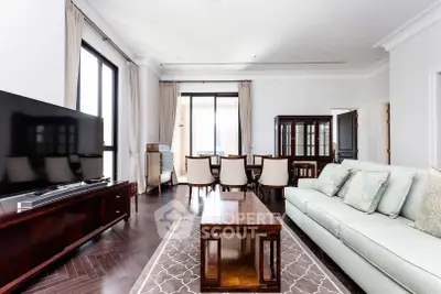 Elegant living room with modern furniture and large windows, featuring a spacious layout and stylish decor.