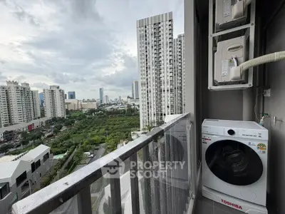 Stunning city view from high-rise balcony with modern washing machine setup.