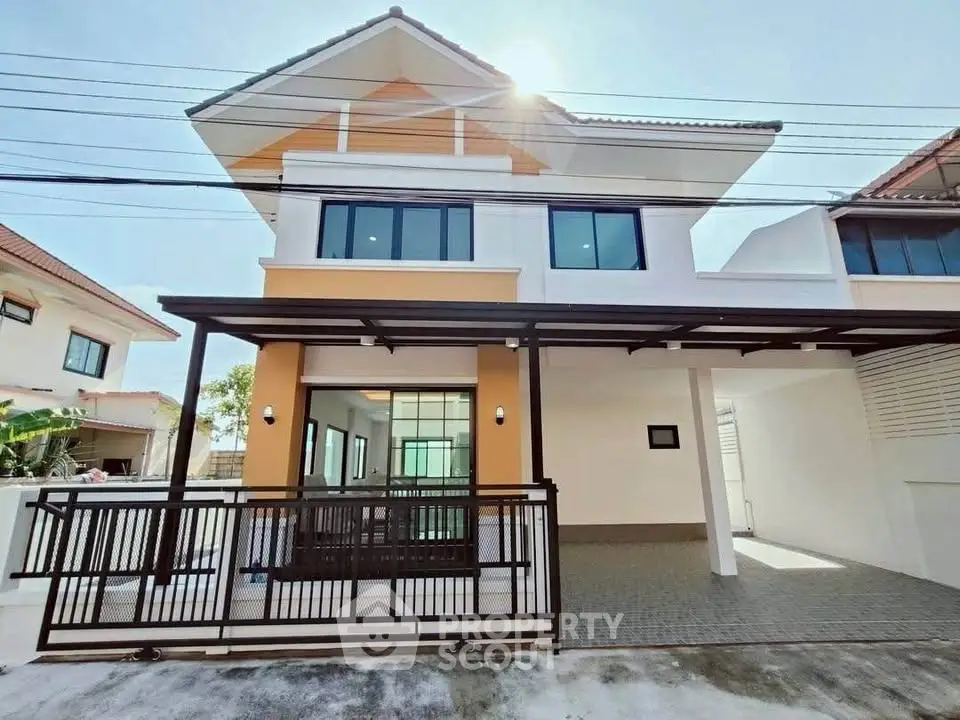 Modern two-story house with a stylish facade and spacious carport in a serene neighborhood.
