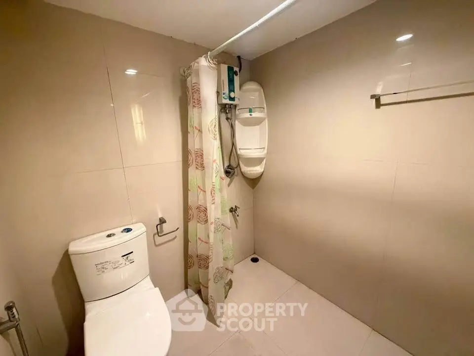 Modern bathroom with sleek design and shower area in a real estate property.