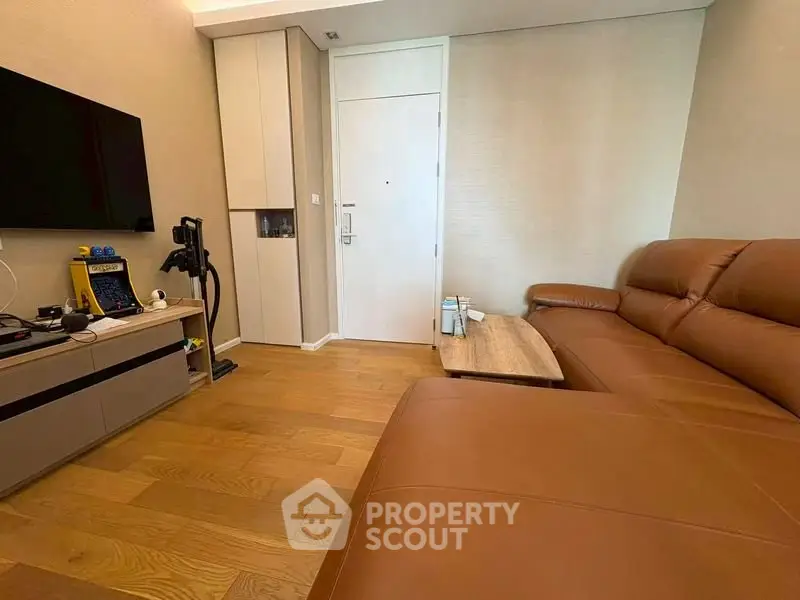 Modern living room with leather sofa and sleek entertainment setup