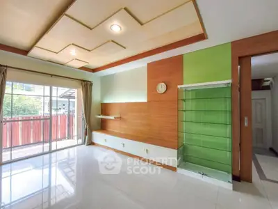 Spacious living room with modern ceiling design and large window for natural light.
