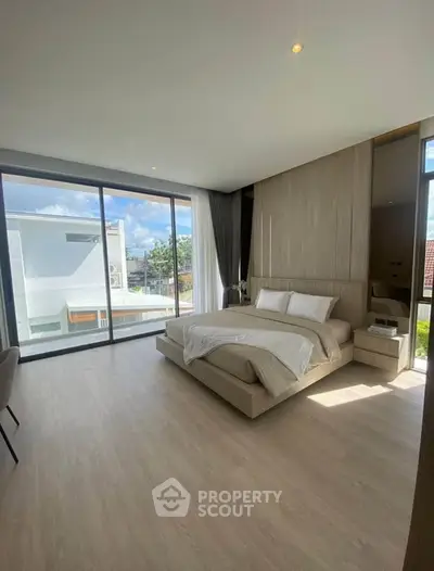 Luxurious bedroom with floor-to-ceiling windows and modern decor