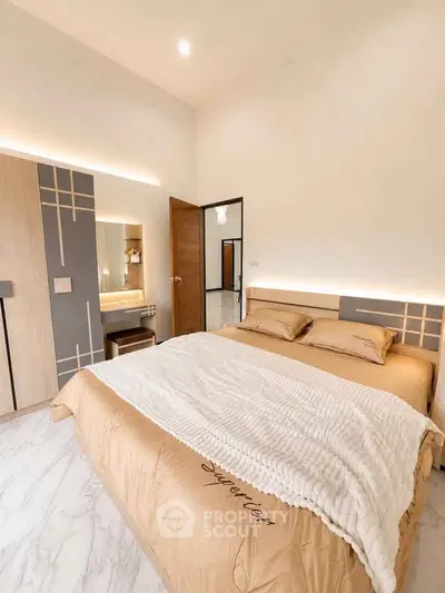 Luxurious bedroom with modern design and elegant lighting, featuring a comfortable bed and stylish decor.