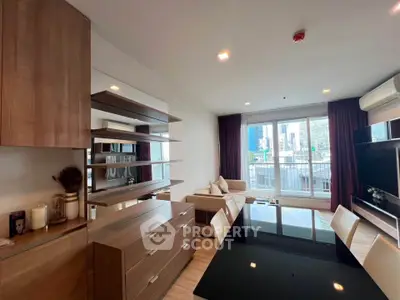Modern living room with city view, featuring sleek furniture and large windows for natural light.