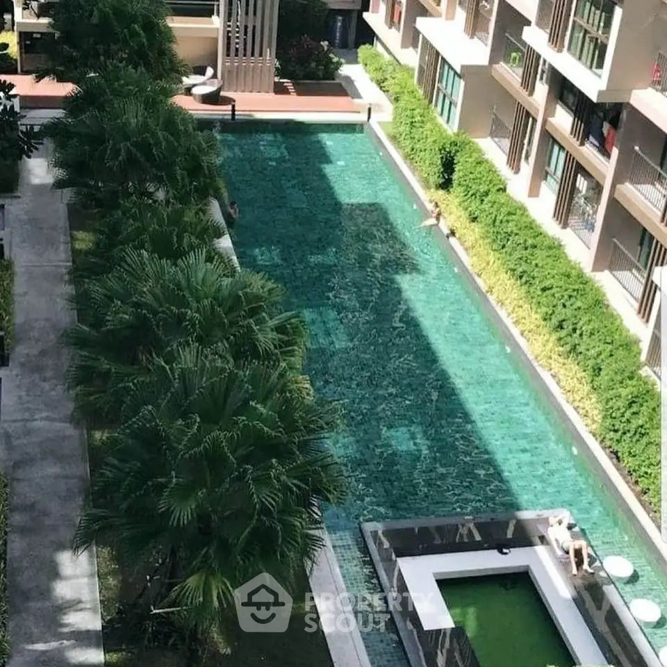 Luxurious apartment complex with a stunning outdoor pool and lush greenery, perfect for relaxation and leisure.