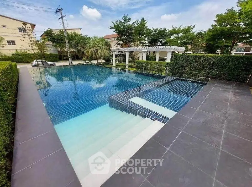 Luxurious outdoor pool with serene surroundings and modern design, perfect for relaxation and leisure.