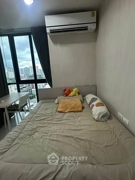 Cozy bedroom with city view, featuring a comfortable bed and modern air conditioning unit.