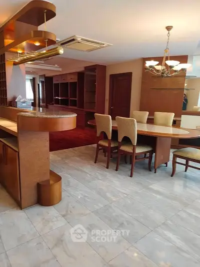 Spacious open-plan living and dining area with elegant wooden furniture and marble flooring.