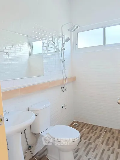 Modern bathroom with white tiles and wood-patterned floor