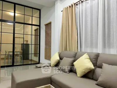 Modern living room with cozy sectional sofa and stylish glass partition