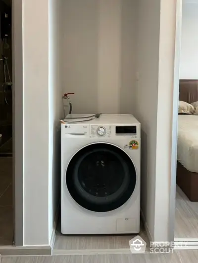 Modern apartment with built-in washing machine in compact laundry nook