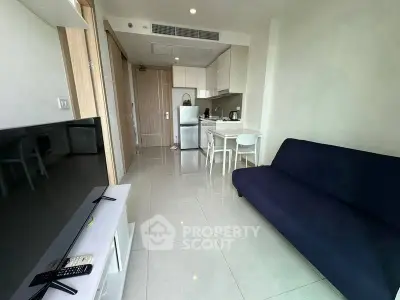 Modern compact living room with open kitchen and sleek furnishings