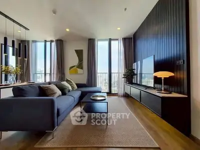 Modern living room with sleek design and city view, featuring a stylish sofa and elegant decor.