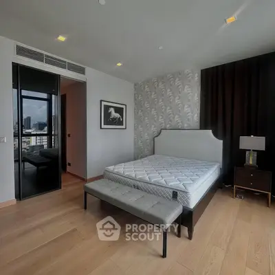 Spacious modern bedroom with elegant decor and city view.