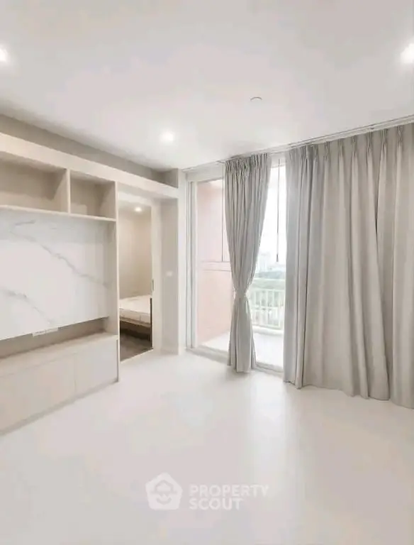 Spacious modern bedroom with large windows and elegant curtains in a luxury apartment.