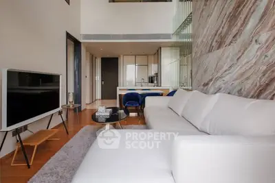 Modern living room with stylish decor and open kitchen layout