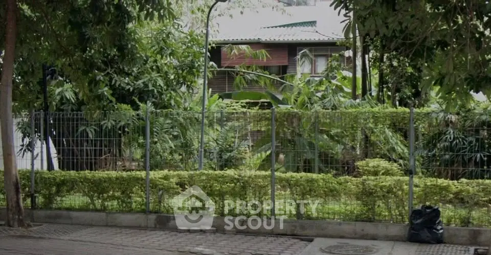 Charming house surrounded by lush greenery and secure fencing, offering a serene and private retreat.