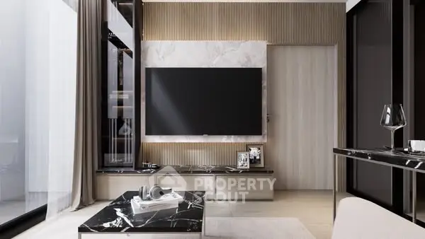 Modern living room with sleek design and large TV, featuring marble accents and elegant decor.