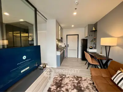 Modern living room with sleek furniture and open kitchen layout in a stylish apartment.