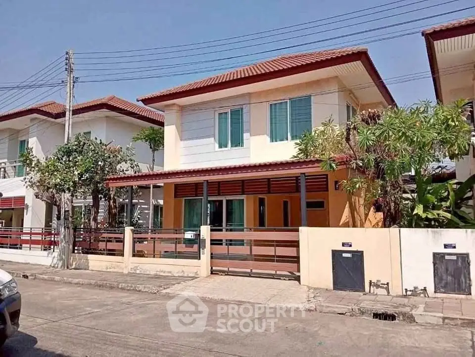 Charming two-story house with modern design and lush greenery in a serene neighborhood.