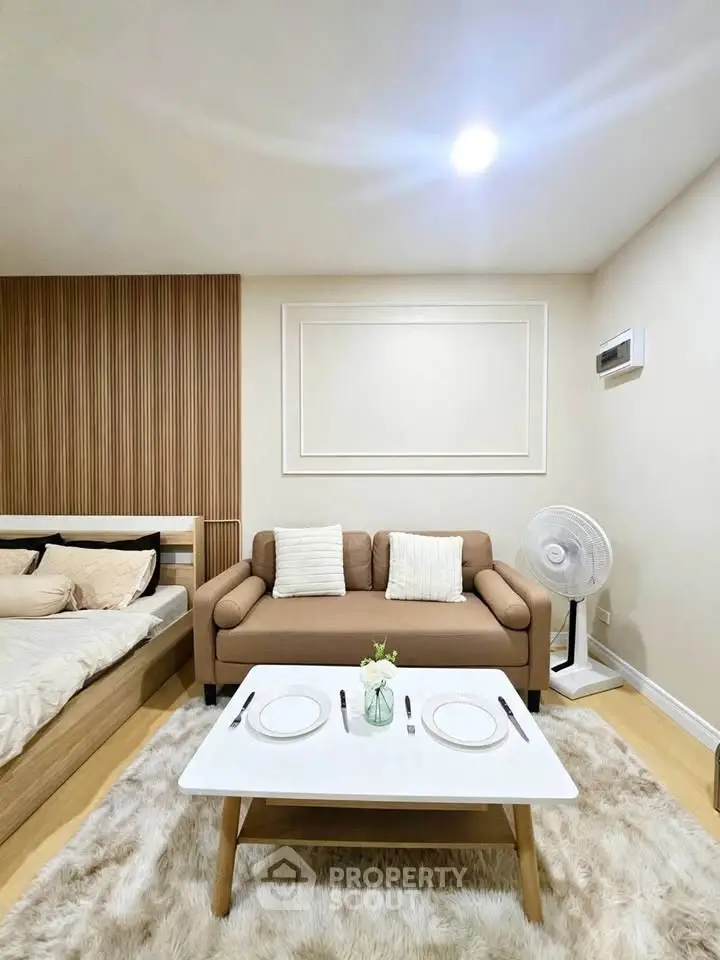 Modern studio apartment with cozy living area and stylish decor