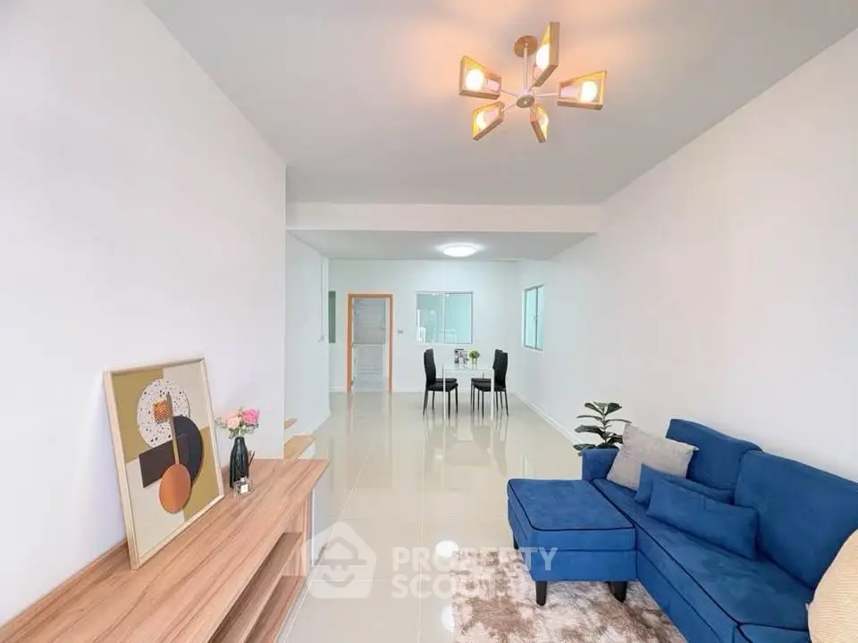 Spacious modern living room with stylish blue sofa and elegant decor