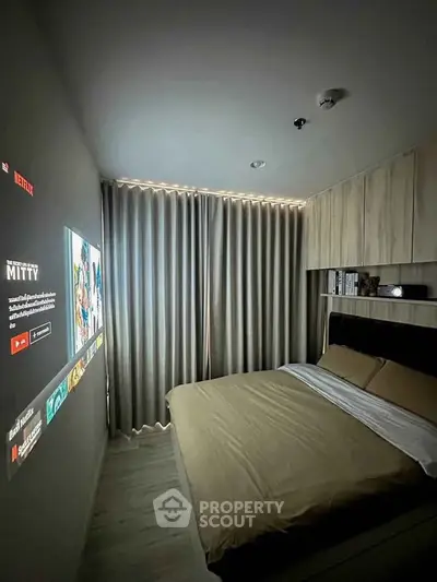 Cozy modern bedroom with projector screen and stylish wooden cabinetry