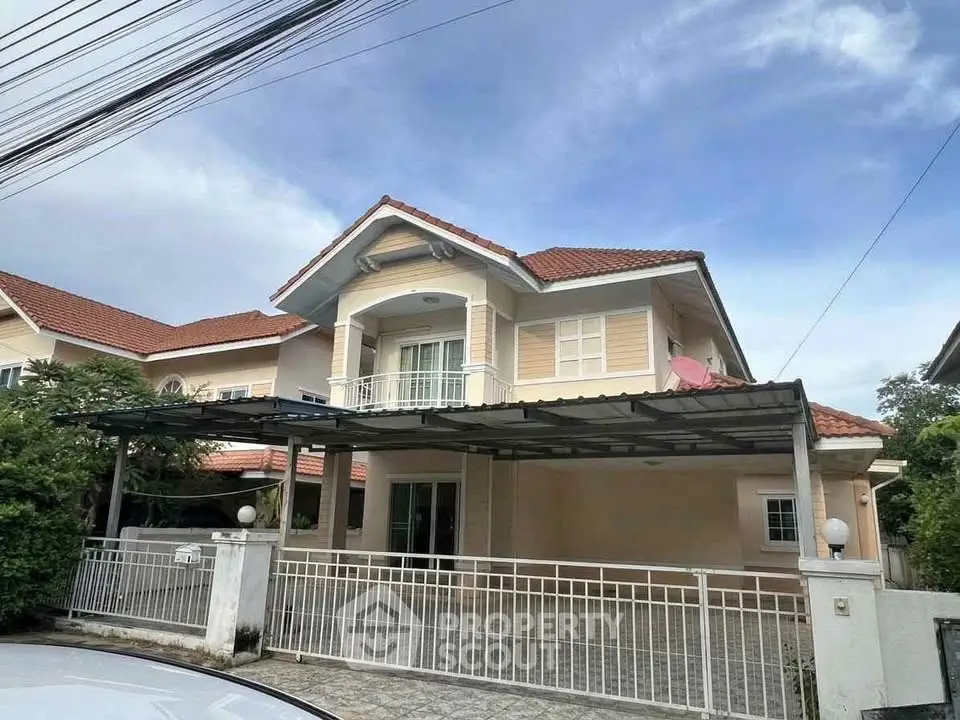 Charming two-story house with red-tiled roof and spacious driveway in a serene neighborhood.