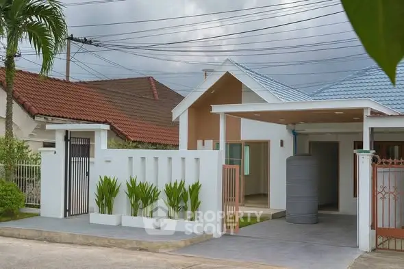 Modern single-story house with carport and landscaped front yard.