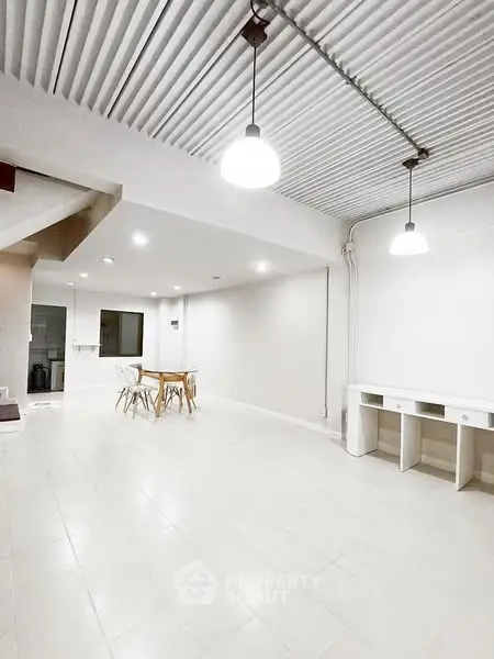 Spacious modern interior with minimalist design and ample lighting, perfect for versatile living or workspace.