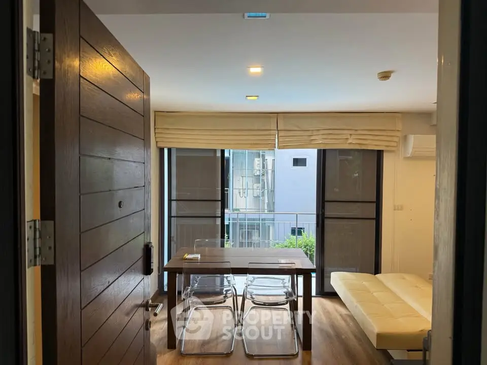 Modern living room with stylish furniture and large windows offering natural light.