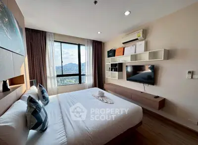 Modern bedroom with scenic view, stylish decor, and wall-mounted TV in a cozy apartment.