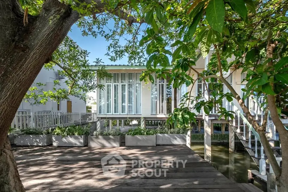 Charming waterfront property with lush greenery and modern architecture.