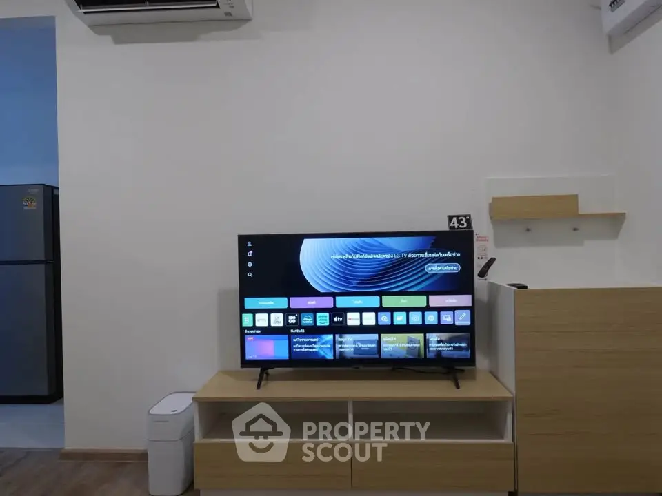 Modern living room with sleek TV setup and stylish wooden furniture, perfect for contemporary living.