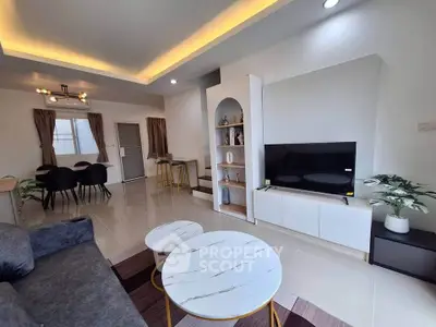 Modern living room with stylish decor and open layout, featuring a cozy seating area and elegant dining space.