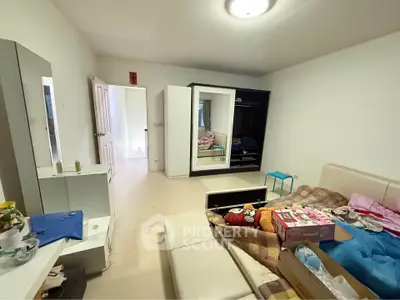 Spacious bedroom with modern wardrobe and cozy bed setup, ideal for comfortable living.