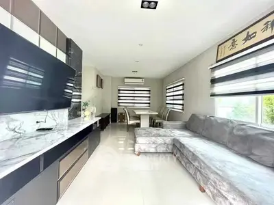 Spacious modern living room with sleek furniture and large windows.